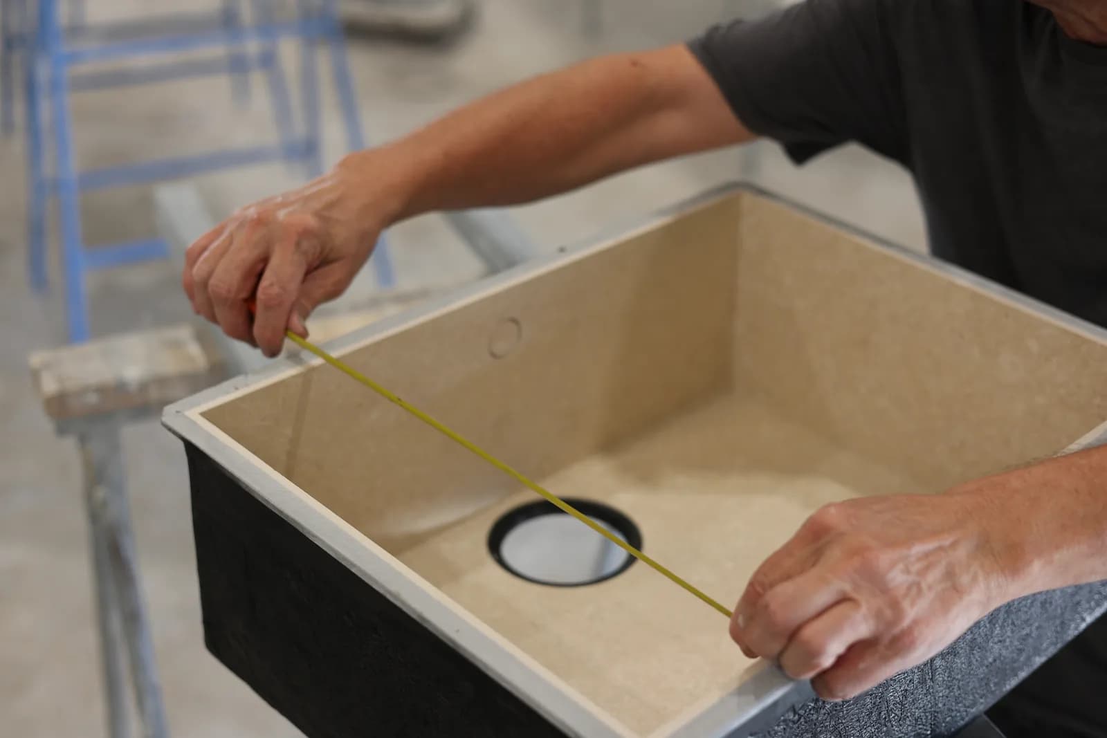 Measuring the internal width of the bowl with a tape measure.