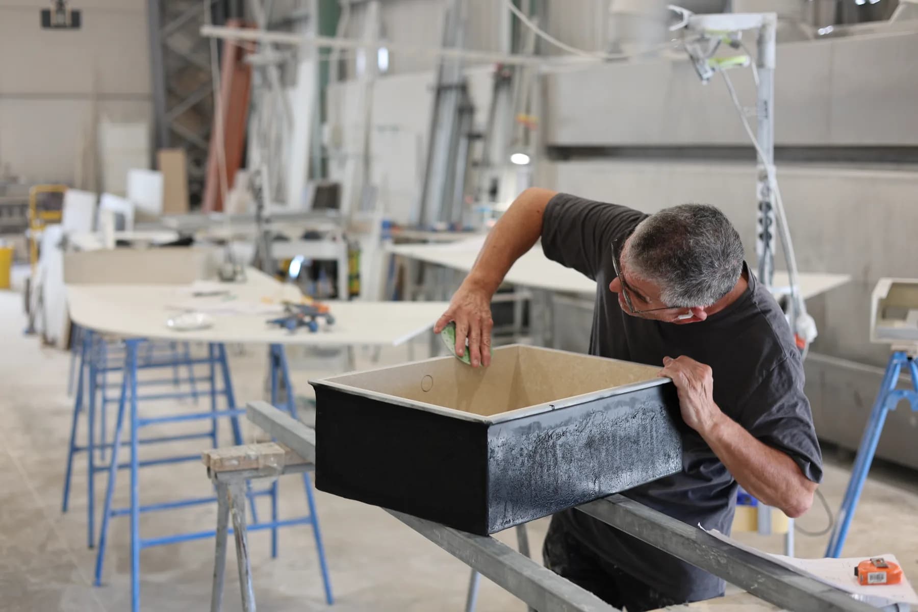 Checking a sink bowl on workshop supports.