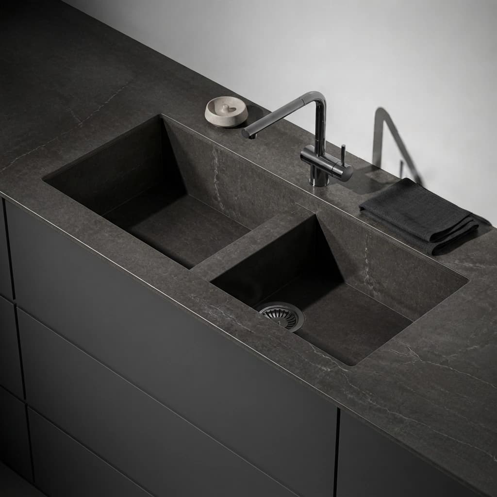 Dekton Soke Vadella countertop with integrated double sink and black faucet